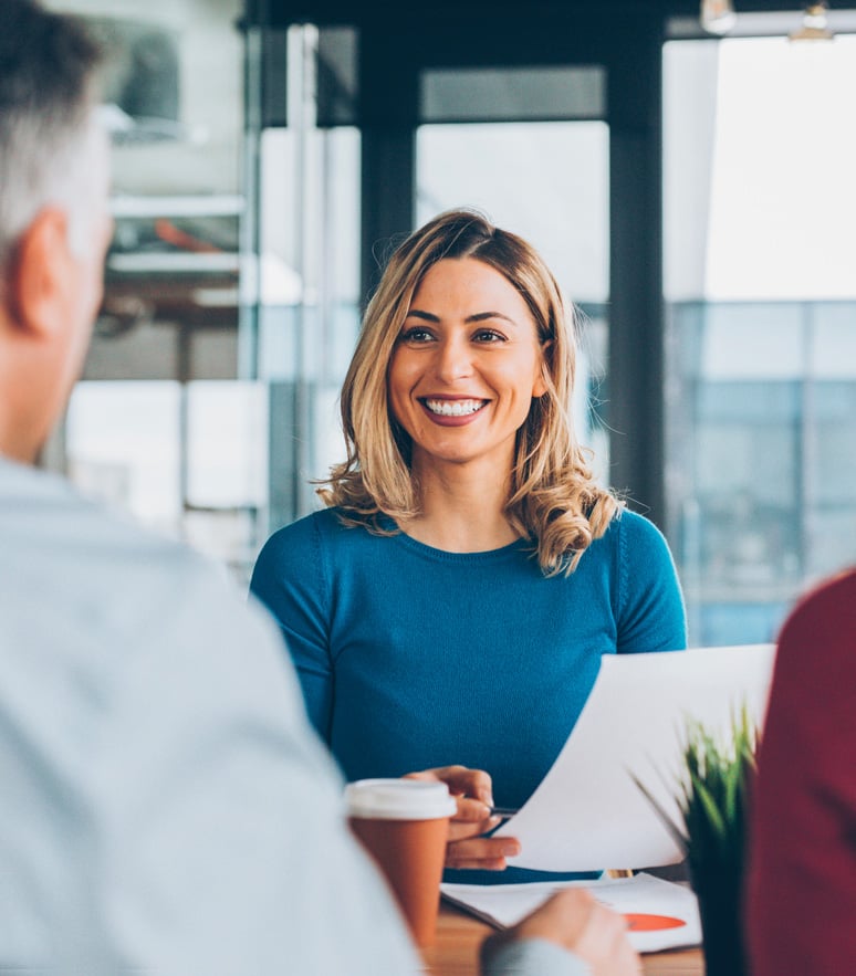 Woman smiling in office with client